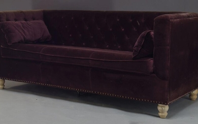 A button back sofa, of recent manufacture, with purple velvet...