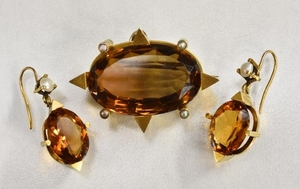 A deep orange stone and seed pearl pendant/brooch and