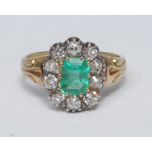 A diamond and emerald cluster ring, central octagonal cut em...