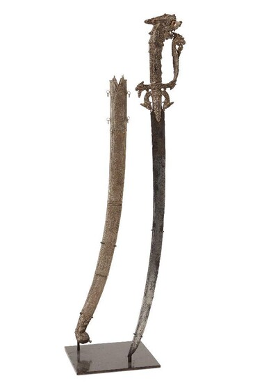 A gem-set silver and gold Singhalese steel sword (kastane) and scabbard, Sri Lanka, 17th century, 60cm. high This kast?né (A Sinhalese sword with a short curved blade) is a ceremonial sword, part of the official dress of Sinhalese who served the...