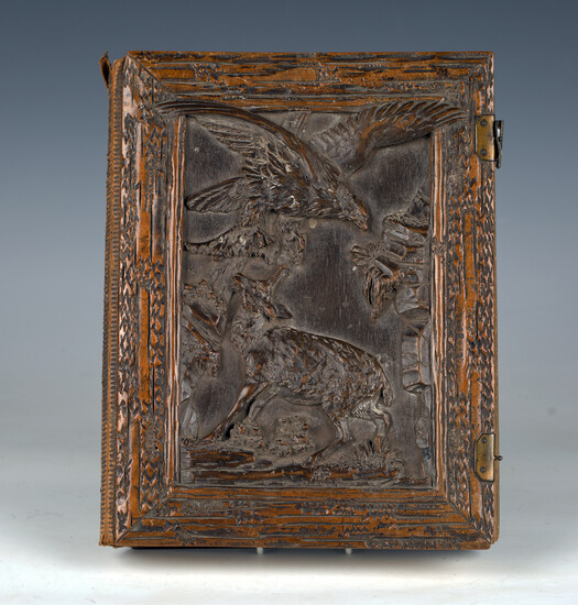 A late 19th century cartes-de-visite album with Black Forest carved softwood covers, the front finel