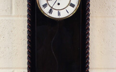 A late 19th century ebonized Vienna style wall timepiece, the two piece enamel dial with Roman hour