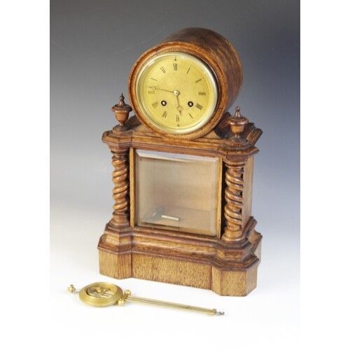 A late 19th century golden oak drum dial mantel clock, the 1...