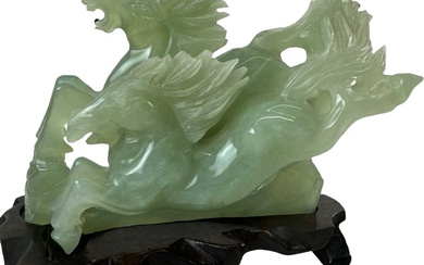 A modern Chinese green carved hardstone of two prancing horses,...