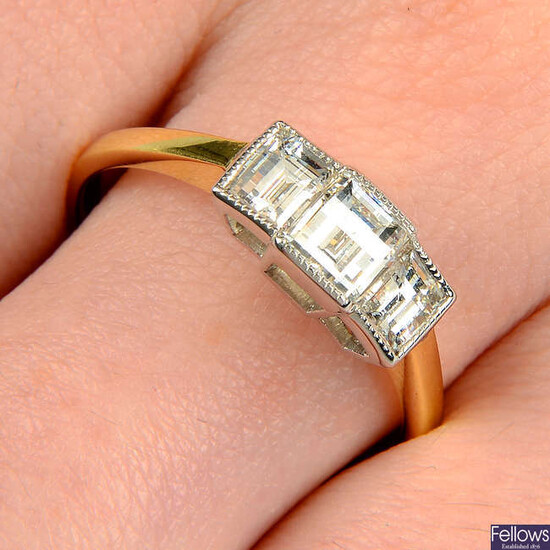 A modified rectangular-shape diamond three-stone ring.