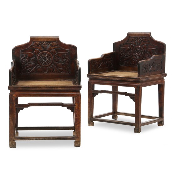 A pair of Chinese hardwood chairs with weaved seats and carved backs and sides. Qing Dynasty, 19th century. (2).