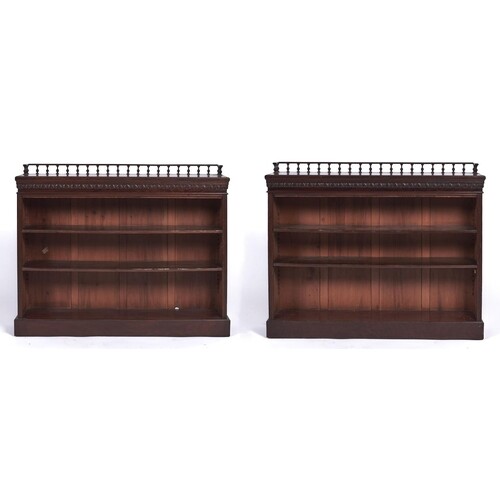 A pair of Edwardian mahogany open bookcases, the rectangular...