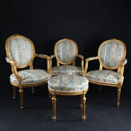 A pair of carved gilt wood armchairs