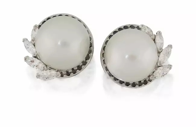 A pair of cultured pearl, diamond and black diamond earrings, each with single cultured pearl,...