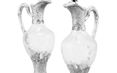 A pair of cut-glass ewers with silver mounts decorated with iris, Puiforcat, Paris, circa 1900 | Paire d’aiguières en verre montées en argent à décor d’iris par Puiforcat, Paris, vers 1900