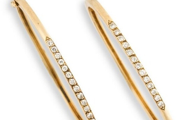 A pair of diamond and fourteen karat gold bangle