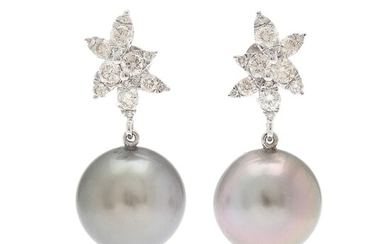 A pair of ear pendants each set with a cultured Tahiti pearl flanked by numerous diamonds weighing a total of app. 1.06 ct., mounted in 18k white gold. (2)