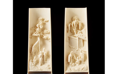 A pair of ivory wrist-rests each carved with a landscape scene, with bases China, 19th/20th century (h. 17.5 cm.)