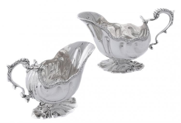 A pair of late Victorian cast silver shaped oval sauce boats by William Hutton & Sons Ltd