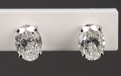 A pair of oval-cut solitaire diamond studs, totaling 1.02 ct. of 18 kt. white gold (2)