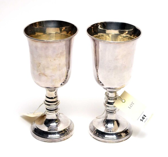 A pair of white metal chalices