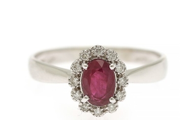 A ruby and diamond ring set with an oval-cut ruby encircled by numerous brilliant-cut diamonds, mounted in 18k white gold. Size 55.