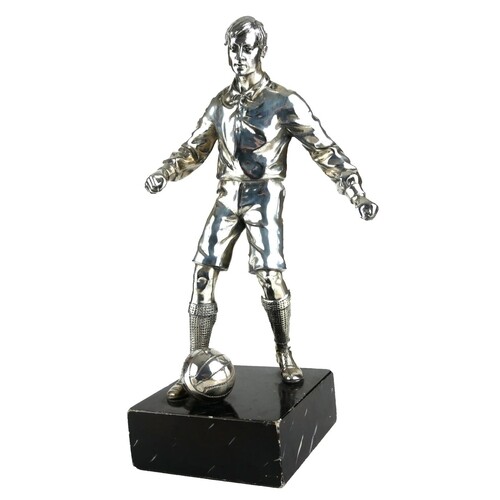 AN EARLY 20TH CENTURY SILVER PLATED STATUE OF A FOOTBALLER. ...