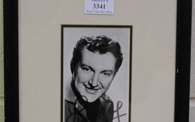AUTOGRAPHS. A black and white photograph signed by Liberace, 14cm x 8.4cm, within a black frame, tog