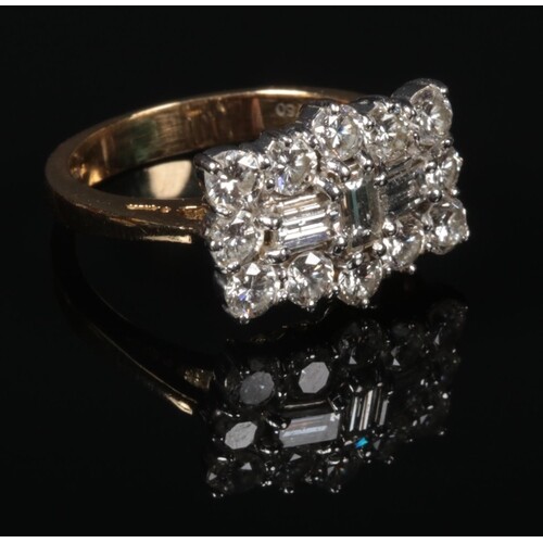 An 18 carat gold diamond cluster ring. Set with three baguet...