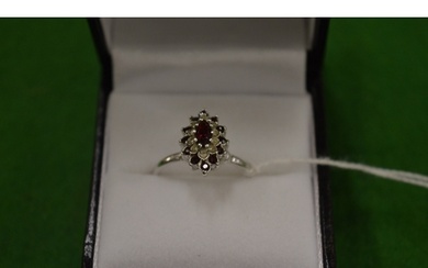 An 18ct white gold, diamond and ruby cluster ring, size O.