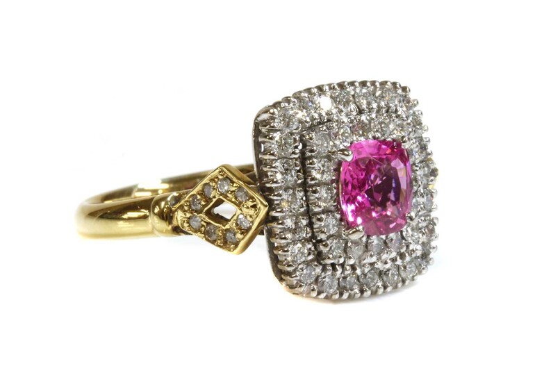 An 18ct yellow and white gold, pink sapphire and diamond cushion-shaped halo cluster ring
