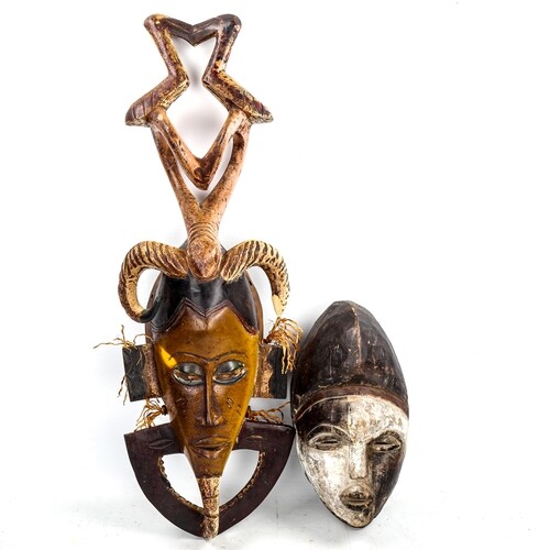 An African carved and painted wood mask, height 73cm, and an...
