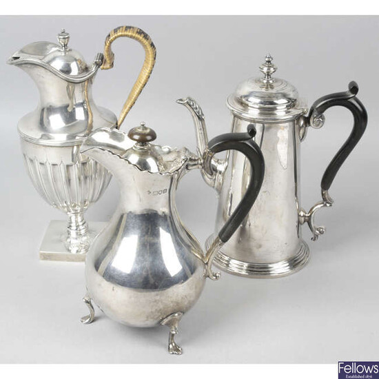 An Edwardian silver coffee pot, together with a late Victorian lidded jug and a further lidded jug. (3).