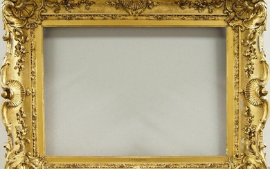 An English Gilded Composition Louis XV Style Swept Frame, mid-late 19th century, with cavetto sight, stiff leaf course, the cross-hatched ogee with foliate and flower head scrollwork, shell cartouche centres and corners, schematic strapwork back...