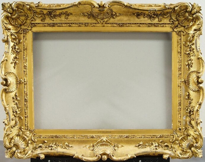 An English Gilded Composition Louis XV Style Swept Frame, mid-late 19th century, with cavetto sight, stiff leaf course, the cross-hatched ogee with foliate and flower head scrollwork, shell cartouche centres and corners, schematic strapwork back...