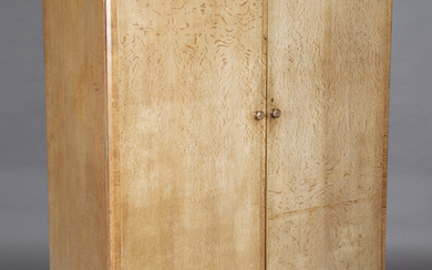 An early 20th century limed oak compactum wardrobe, in the manner of Heals, the two doors enclosing