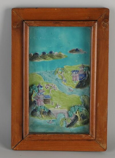 Antique Chinese porcelain relief plaque in display