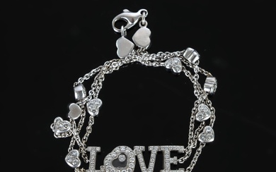 CHOPARD. Bracelet articulé en or gris "Happy diamonds" composé de 3 chainettes alternées de petits...