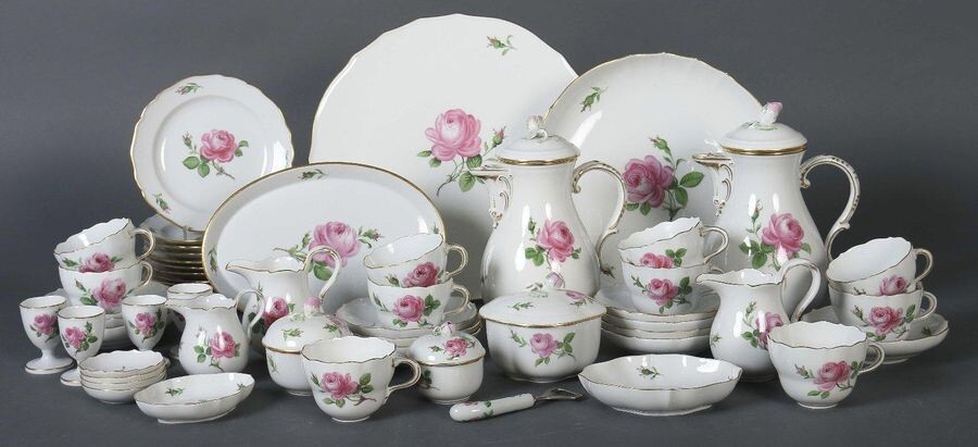 Coffee and breakfast service ''Rote Rose'' Meissen, mostly after 1950 (17 pieces 1924-34), porcelain, glazed and painted with single red roses and rosebuds in mouldy colours, the buds as rosebuds, gold grained, 53 pcs. dam. made of small round bowls...