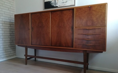 Danish furniture design: Sideboard of nutwood, front with drawers and doors, inside with shelves and pullout leaves. H. 123 cm. L. 200 cm. W. 42–44 cm.