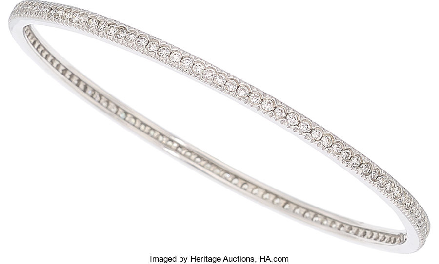 Diamond, White Gold Bracelet The bangle features full-cut diamonds...