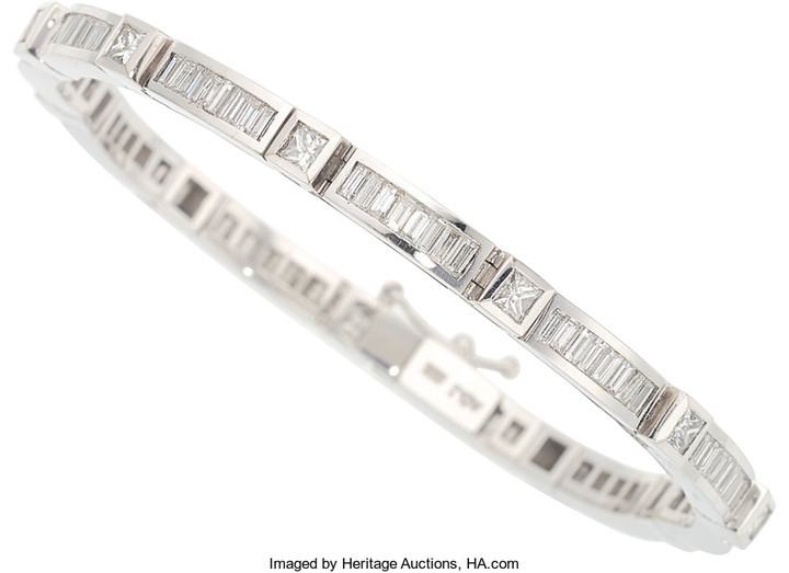 Diamond, White Gold Bracelet The bracelet features baguette-cut...