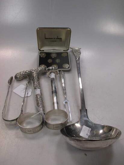George III silver sugar tongs, 2 napkin rings, 8 plated buttons by Benson and Clegg, an Indian