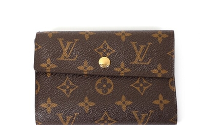 NOT SOLD. Louis Vuitton: A "Alexandra" wallet made of brown monogram canvas with gold toned...