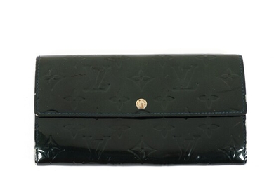 NOT SOLD. Louis Vuitton: A "Sarah" wallet made of dark green monogram embossed Vernis leather...