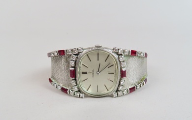 OMEGA. Montre bracelet de dame, l'ensemble en or blanc (750/00) serti de diamants et rubis....