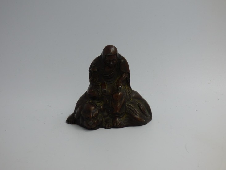 Oriental cast model of a seated elder holding a scroll 6 cm
