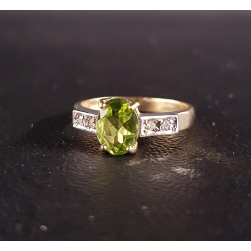 PERIDOT AND DIAMOND RING the central oval cut peridot approx...