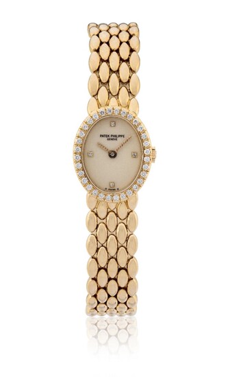 Patek Philippe. A lady's 18ct gold and diamond set bracelet watch with fitted box, Certificate D'Origine, spare links and service papers, Ref: 4751/001, Movement No. 1'604'735, Made 1989 Cream dial with applied gold and diamond dot quarters, gold...