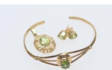 Peridot set bangle, oval cut stone in an openwork unmarked g...