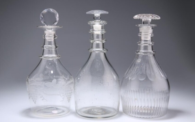 THREE GEORGIAN GLASS DECANTERS, the first with