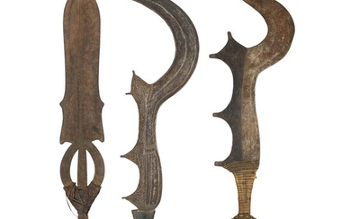 ‡TWO AFRICAN SICKLE-SHAPED SHORTSWORDS (NGOMBE DOKO) AND A BROADSWORD (DOKO MOBAMPA)