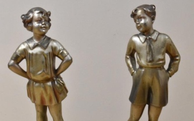 Two early 20th Century bronze studies of young boy and girl on stepped onyx bases, each measuring