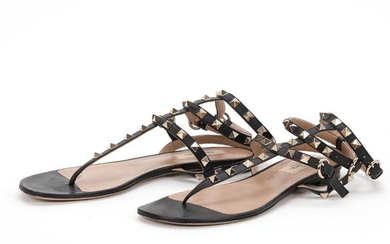 Valentino A pair of sandals of black leather embellished with golden studs...
