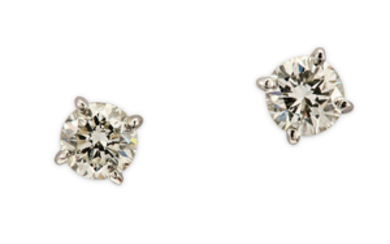 A pair of diamond earstuds Each brilliant-cut diamond,...